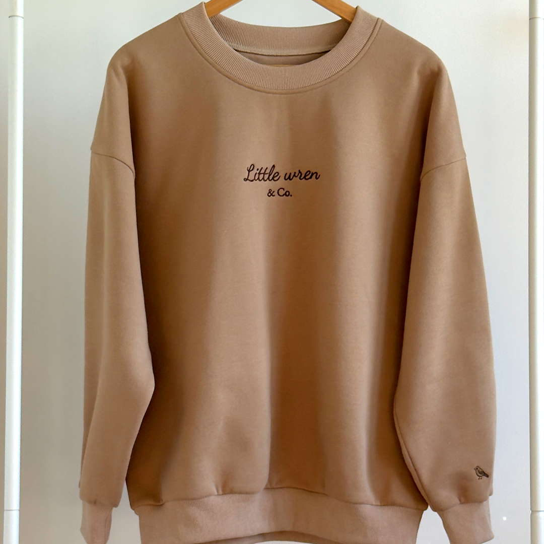 Brown sweatshirt with 'Little Wren & Co.' text on a white background