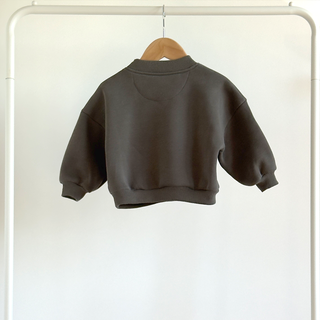 baby's sweatshirt on a hanger against a white background